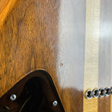 Close-up detail of a wooden guitar body showing a glossy dark brown finish, a black pickguard, and a light wood stripe along the side.