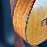 Close-up of a wooden acoustic guitar on a dark background