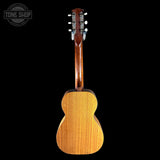 Back view of a wooden guitar with 'Tone Shop' logo in the corner.