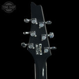 Close-up of the back of a black electric guitar headstock with six silver tuning pegs and a visible SR logo, shown against a black background.