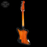 Electric guitar with a sunburst finish on a black background, featuring the Tone Shop logo.