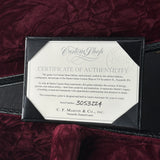 Certificate of authenticity for a C.F. Martin & Co. guitar on a dark red fabric background