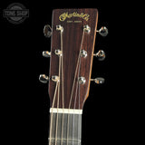 Guitar headstock with Martin & Co logo on a black background