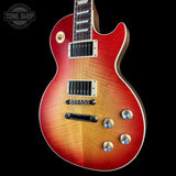Electric guitar with a sunburst finish on a black background, featuring the Tone Shop logo.