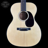 Acoustic guitar with a visible brand logo in the corner