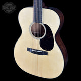 Acoustic guitar with a visible brand logo on a black background