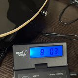Used Vintage Single Cut Black on scale displaying weight.