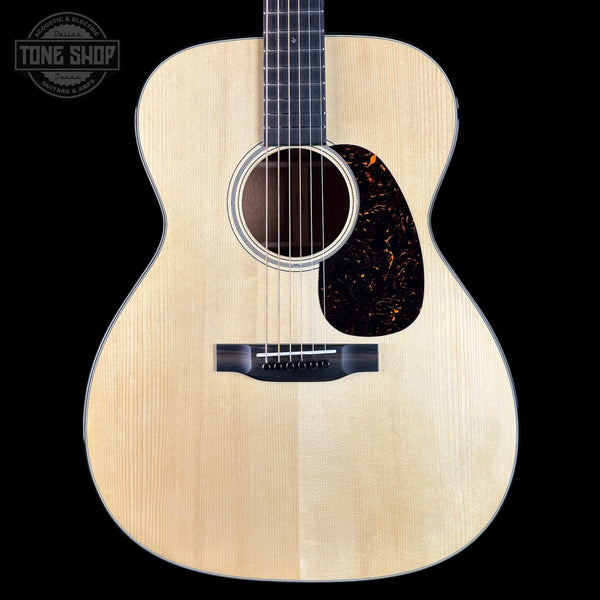 Acoustic guitar with a visible brand logo in the corner