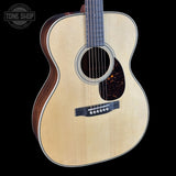 Acoustic guitar with a visible brand logo in the corner