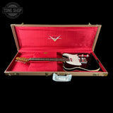A black electric guitar with a white pickguard resting inside an open brown hard case with bright red velvet lining. The Fender logo is visible on the inner lid, and a Tone Shop watermark is in the top-left corner.