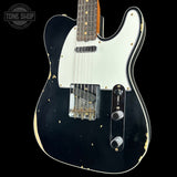 A classic Fender Telecaster electric guitar with a black body, white pickguard, and distressed gold paint details, shown against a solid black background with a Tone Shop logo in the top left corner.