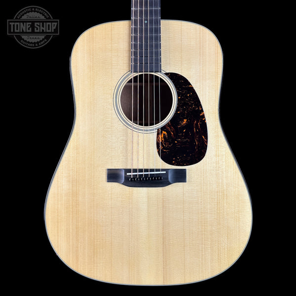 Acoustic guitar with a visible brand logo in the corner