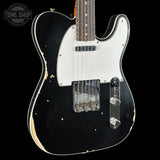 A classic Fender Telecaster electric guitar with a black body, white pickguard, and distressed finish showing wood grain and wear, photographed against a solid black background.