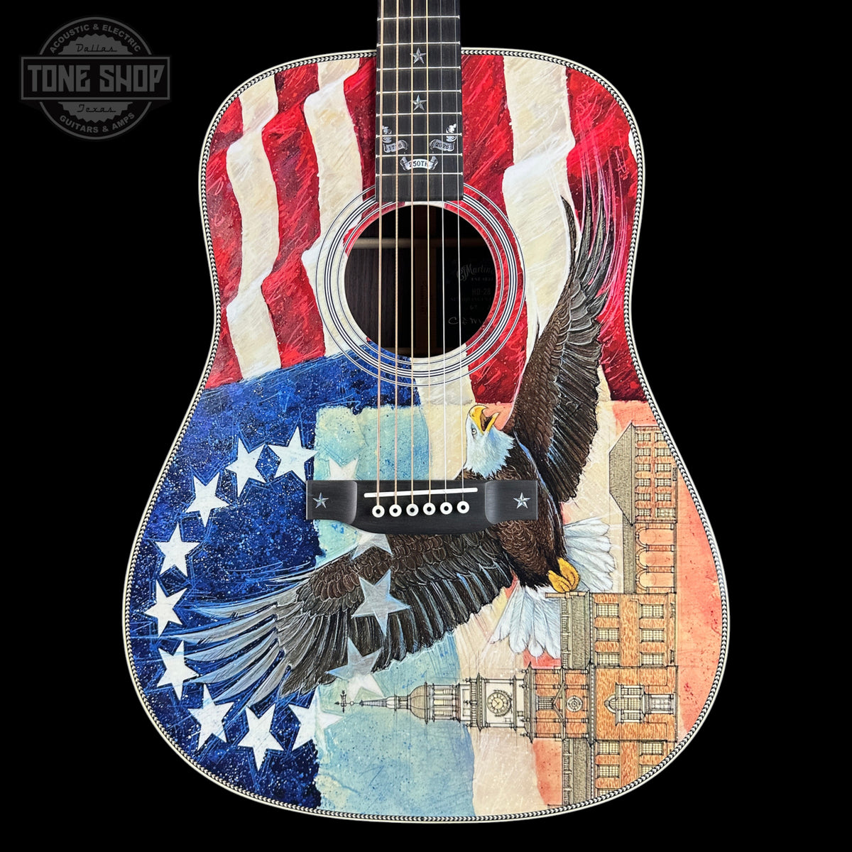 Acoustic guitar with American flag and eagle design on a black background