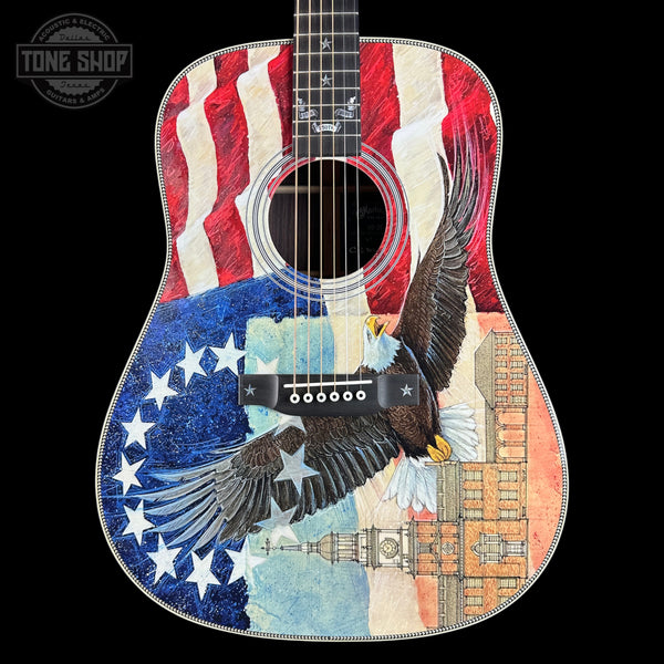 Acoustic guitar with American flag and eagle design on a black background