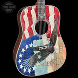 Acoustic guitar with American flag and eagle design on a black background