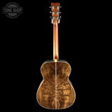 Wooden acoustic guitar on a black background with 'Tone Shop' logo.