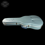 Light blue guitar case with 'Fender' branding on a black background