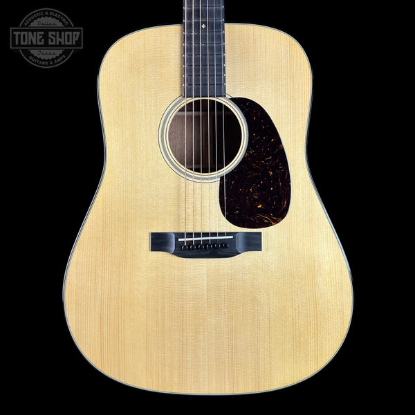 Acoustic guitar with a visible brand logo in the corner