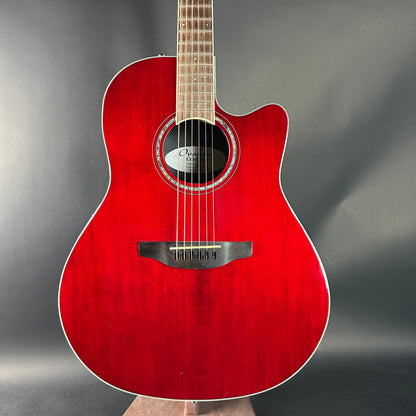 Red acoustic guitar on a gray background