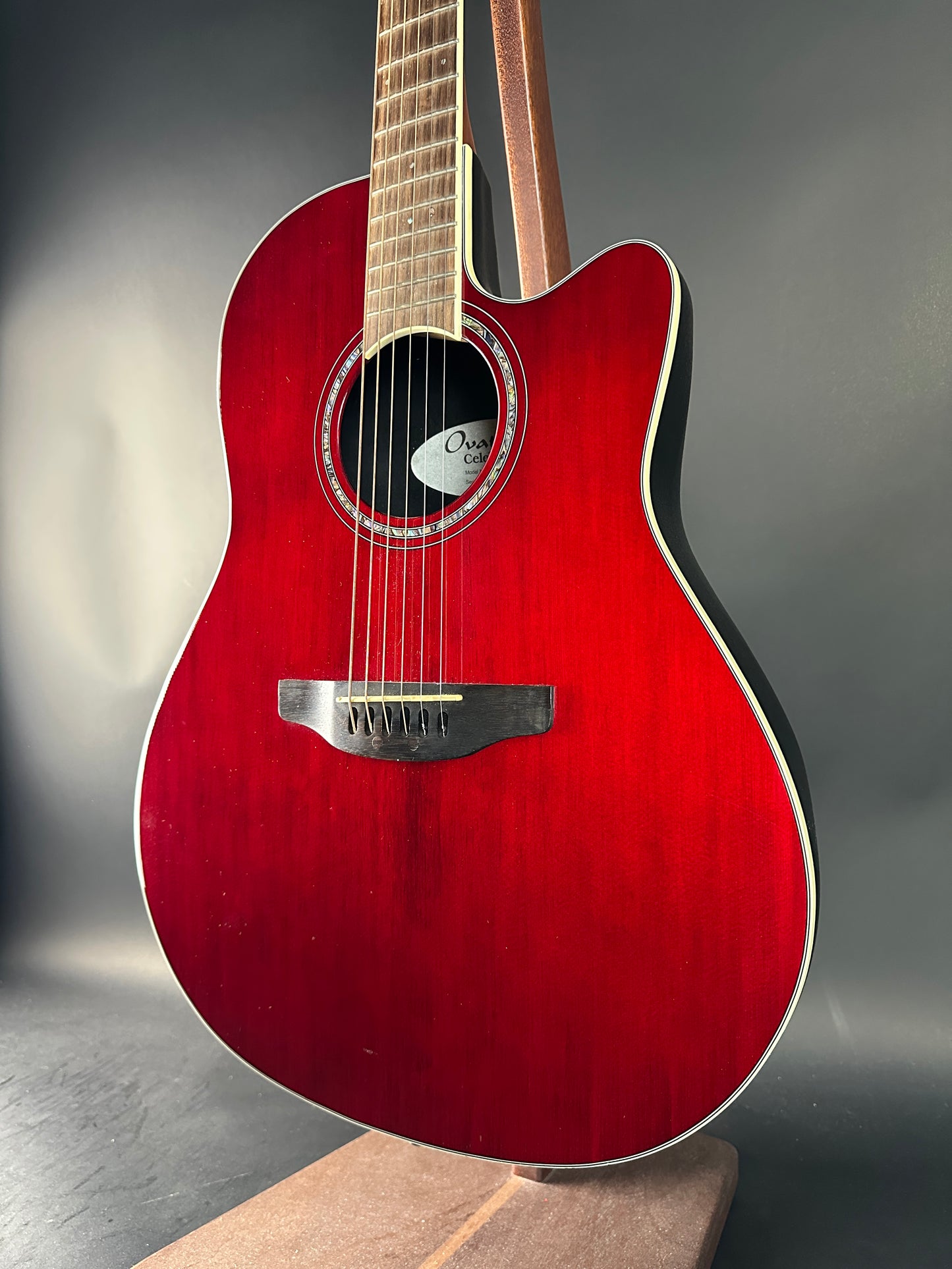 Red acoustic guitar on a gray background