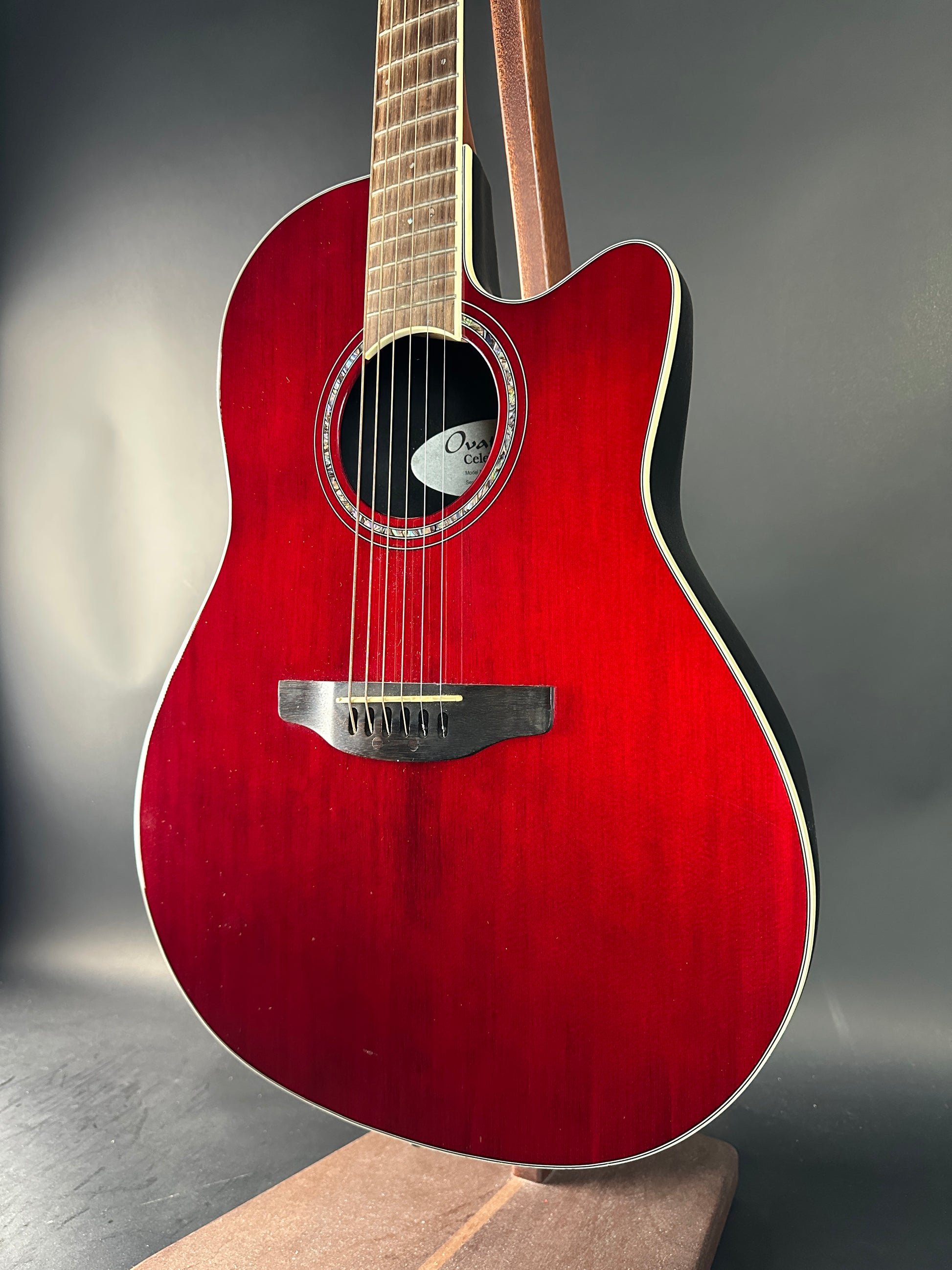 Red acoustic guitar on a gray background