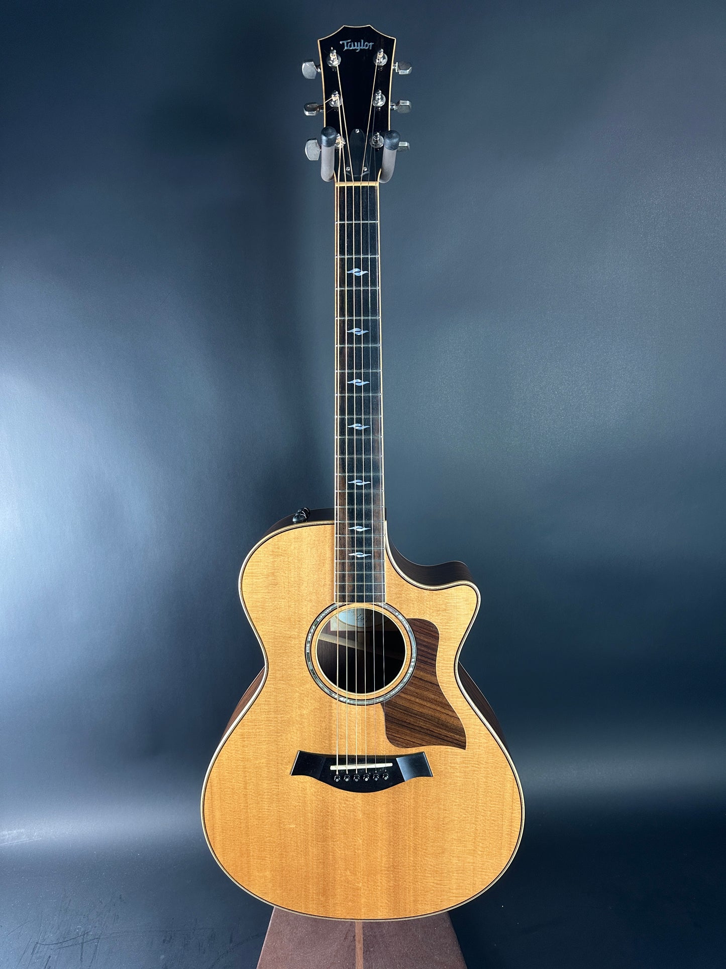 Acoustic guitar on a dark blue gradient background