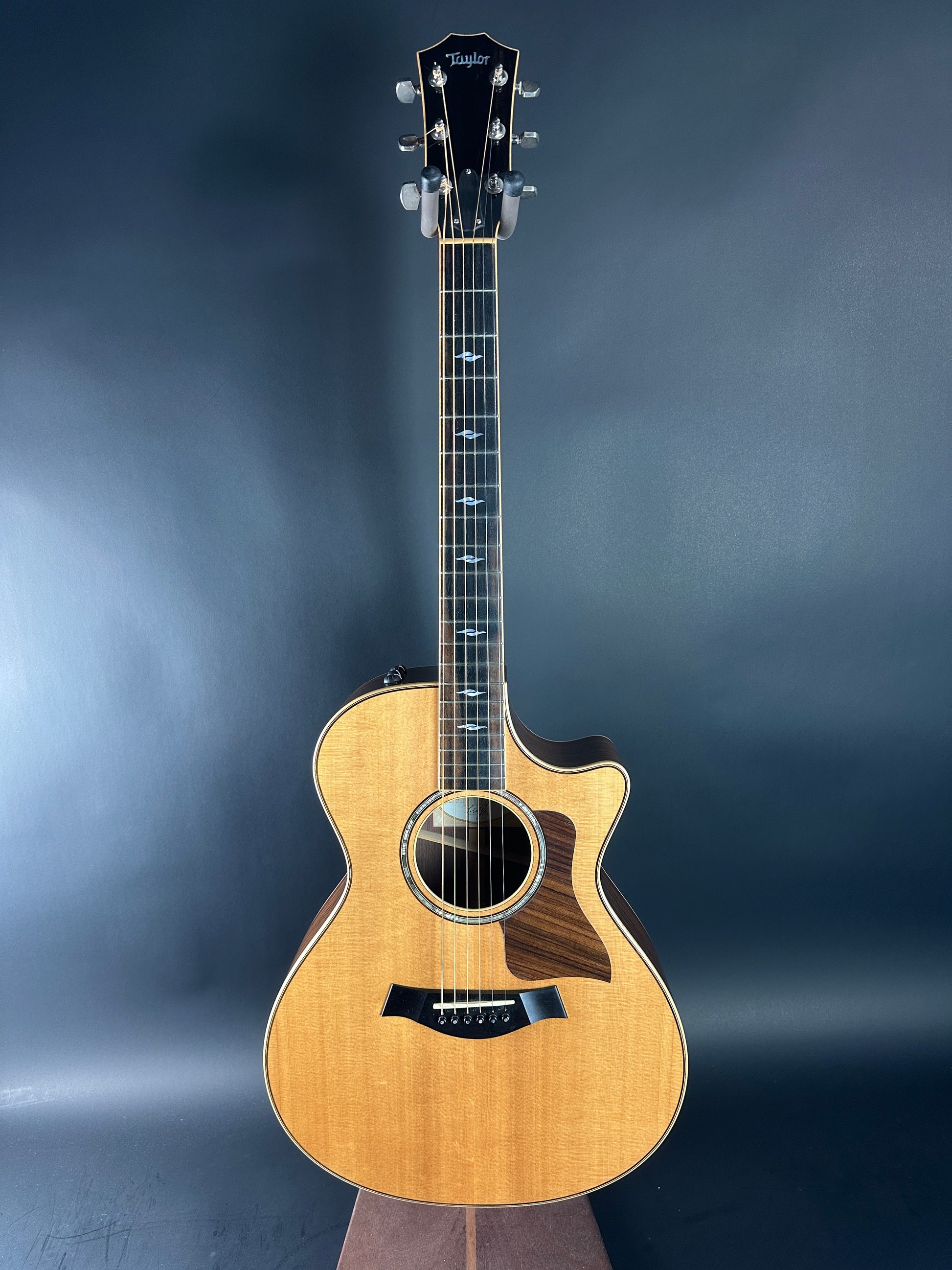 Acoustic guitar on a dark blue gradient background