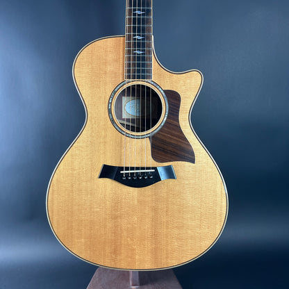 Acoustic guitar with a wooden finish on a dark blue background