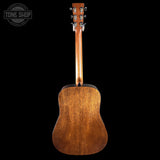Back view of a wooden acoustic guitar with 'Tone Shop' logo in the corner.