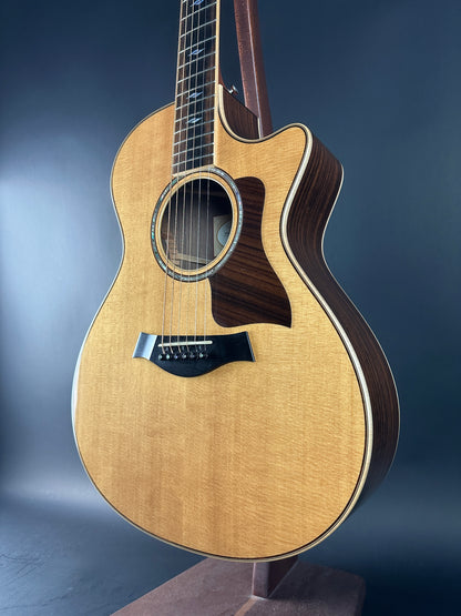 Acoustic guitar with a wooden finish on a dark blue background