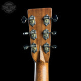 Close-up of a guitar headstock with tuning pegs on a black background, featuring 'Tone Shop' branding.