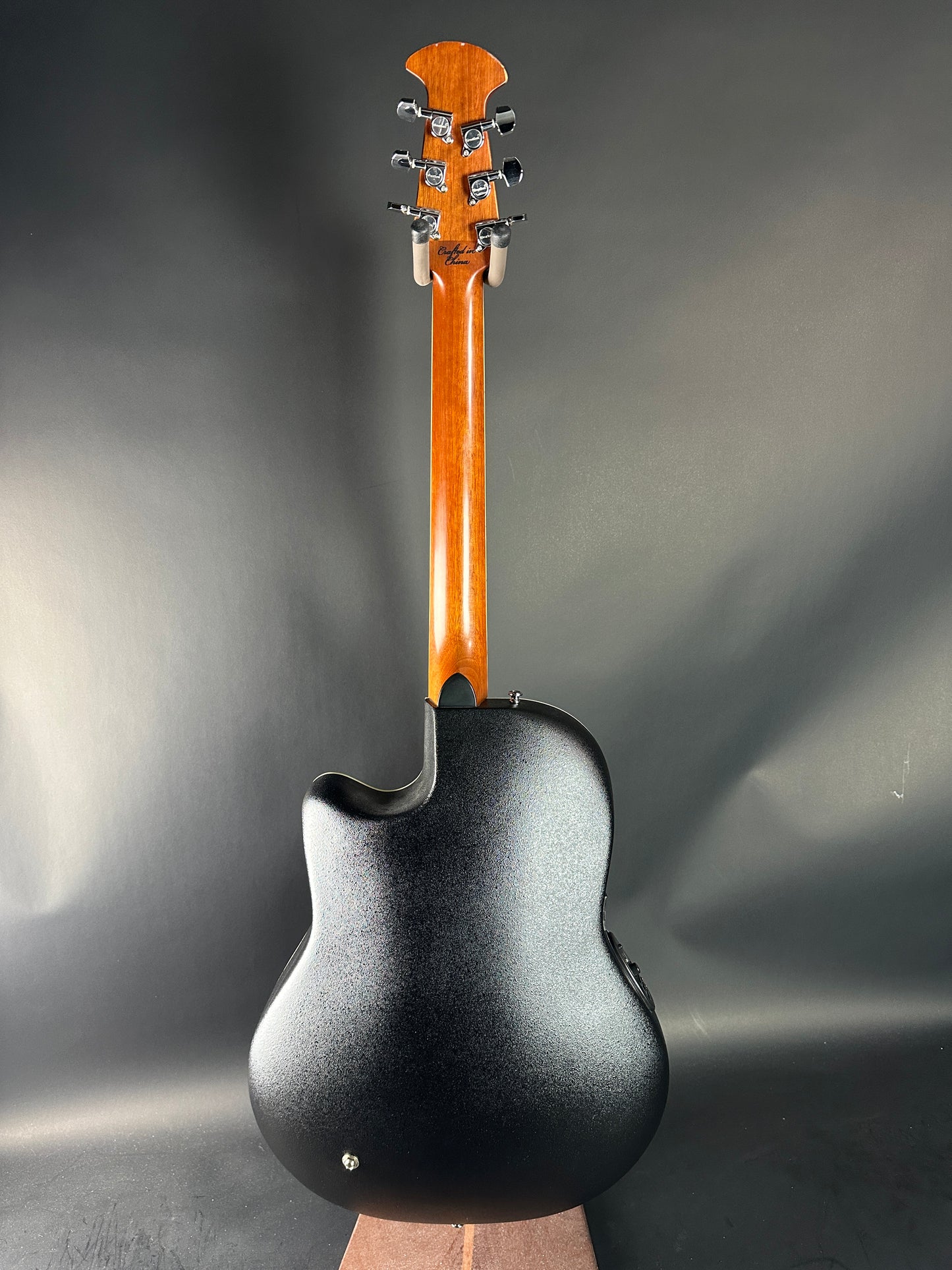 Guitar headstock and neck on a dark gray background