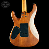 The back of an electric guitar with a natural wood finish, featuring black pickguard plates and control knobs, shown against a solid black background.