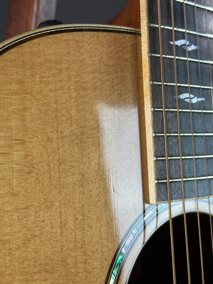Wear near soundhole of Used Taylor 812ce Natural.