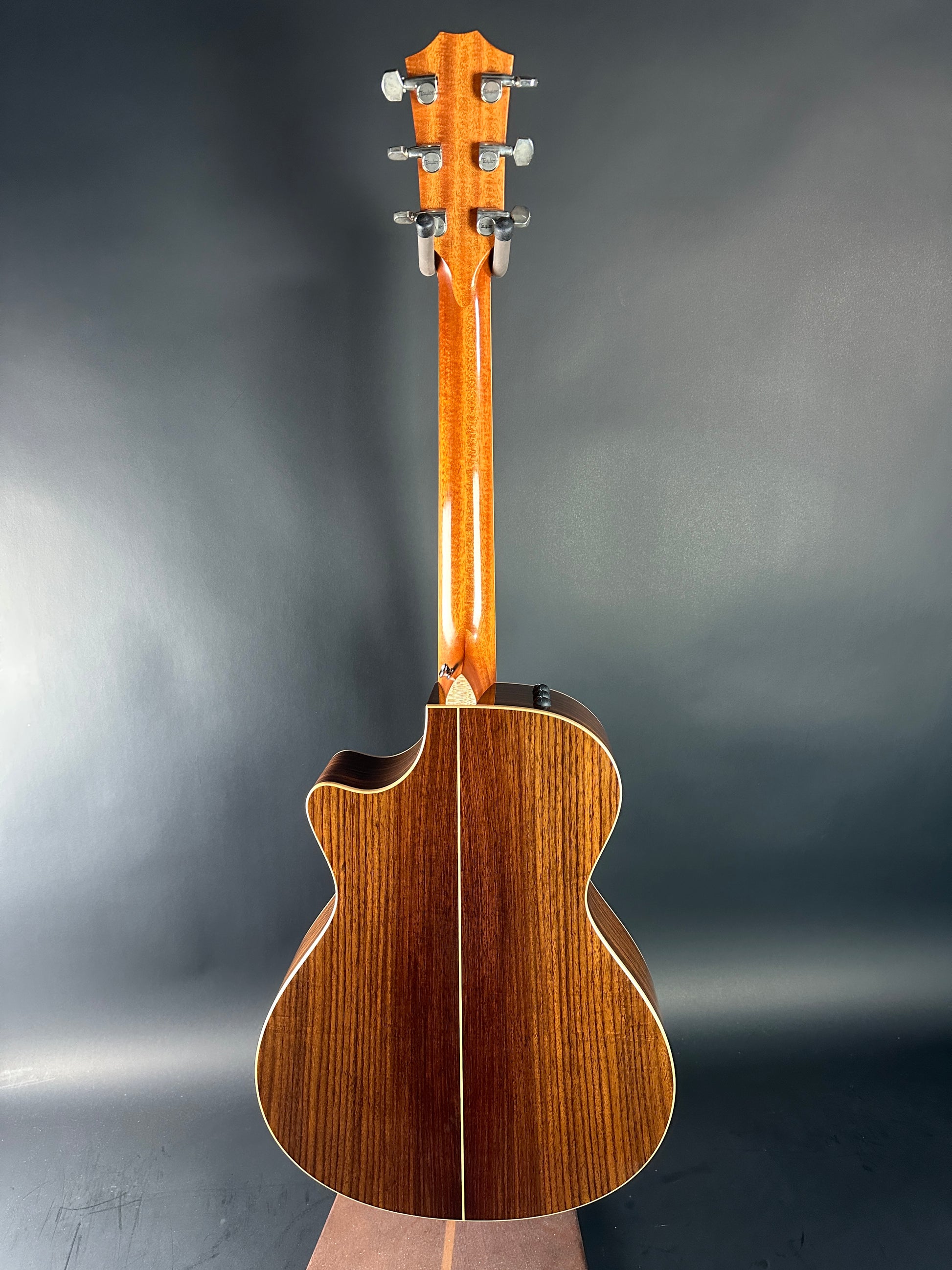 Wooden acoustic guitar on a gray background