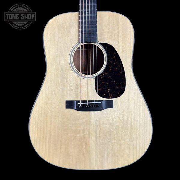 Acoustic guitar with a visible brand logo in the corner