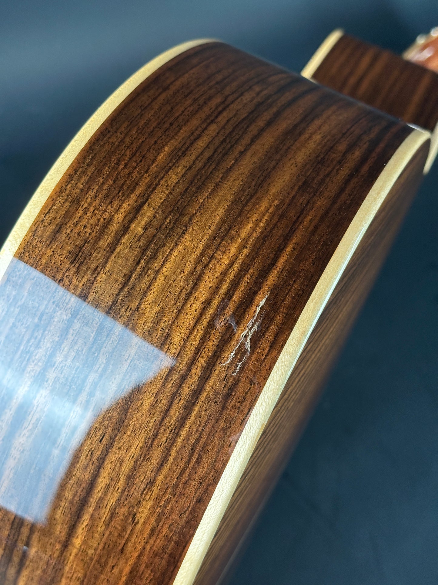 Damage on bottom of Used Taylor 812ce Natural.