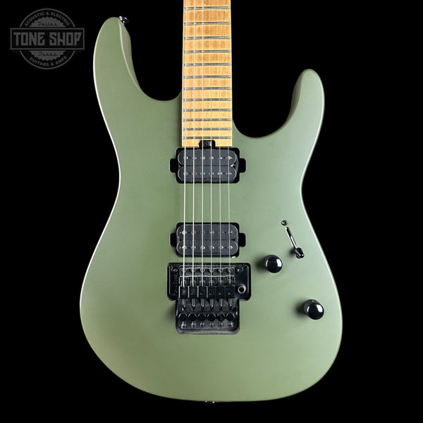 An electric guitar with a matte sage green body, maple neck, and black hardware, shown against a solid black background with a Tone Shop watermark in the top-left corner.