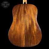 Close-up of a wooden acoustic guitar body with 'Tone Shop' logo.
