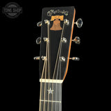 Guitar headstock with 'Martin & Co.' logo on a black background