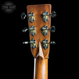 Close-up of a guitar headstock with tuning pegs on a black background, featuring the Tone Shop logo.
