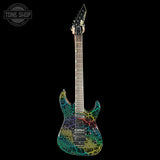A modern electric guitar with a vibrant multicolor crackle pattern on a black body, shown against a solid black background with a Tone Shop watermark in the top-left corner.