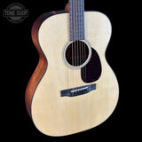 Acoustic guitar with a visible brand logo on a black background