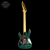 A custom electric guitar shown from the back against a solid black background, featuring a vibrant multicolor crackle paint design on a black base, a natural maple neck, and a gold headstock.