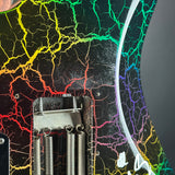 Close-up of an electric guitar body featuring a black base with a vibrant, multicolor crackle pattern in yellow, green, blue, purple, and red. A silver metal bridge and springs are visible at the bottom.