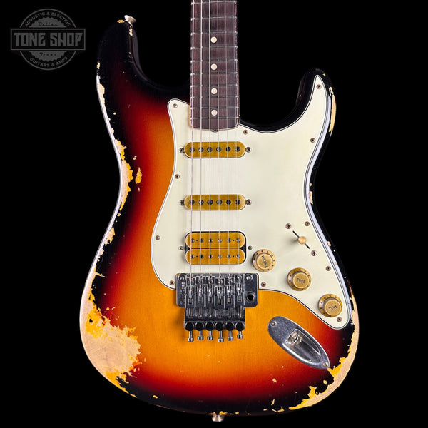 Worn electric guitar with a sunburst finish on a black background, featuring 'Tone Shop' branding.