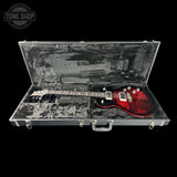 Red electric guitar in an open case with 'Tone Shop' logo.