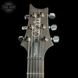 Guitar headstock with 'Tremonti' branding on a black background