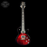 Electric guitar with a red and black finish on a black background, featuring the Tone Shop logo.